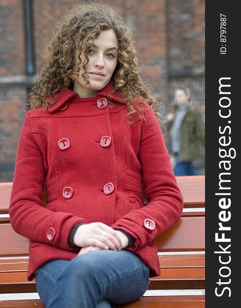 Teenage girl in Poland, portrait. Young girl with curly hairs wearing red coat, posing in Wroclaw city. Teenage girl in Poland, portrait. Young girl with curly hairs wearing red coat, posing in Wroclaw city.