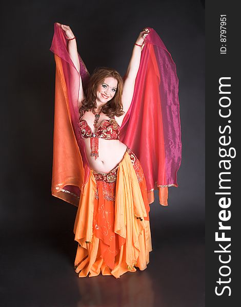Belly Dancer wearing a red costume with jewelery. Belly Dancer wearing a red costume with jewelery
