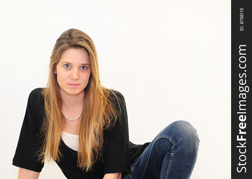 Attractive red head girl on white background in jeans and black shirt. Attractive red head girl on white background in jeans and black shirt