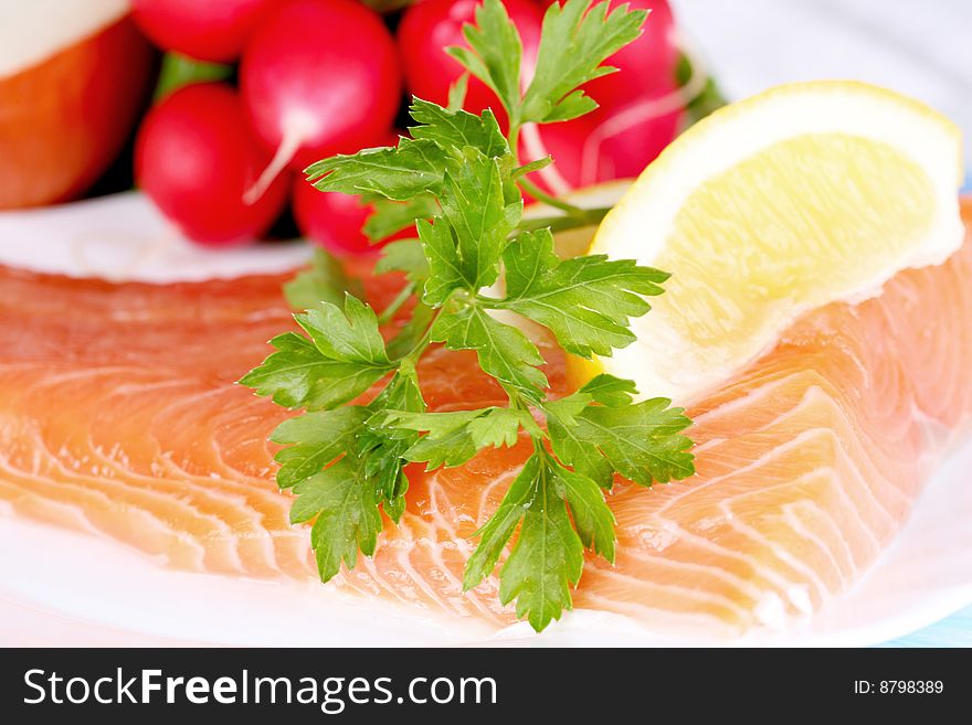 Fresh salmon with parsley, lemon and radish. ready to cook