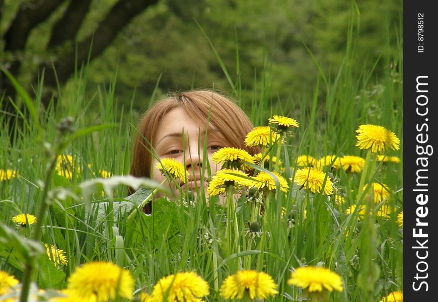 Girl on the field from dandelions