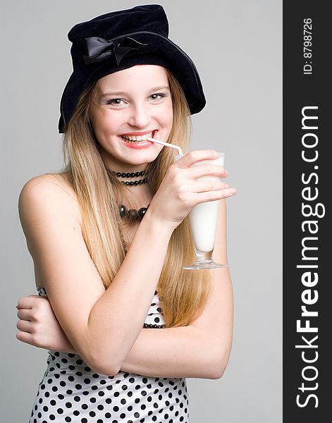 Laughing girl with a glass of milk cocktail portrait. Laughing girl with a glass of milk cocktail portrait