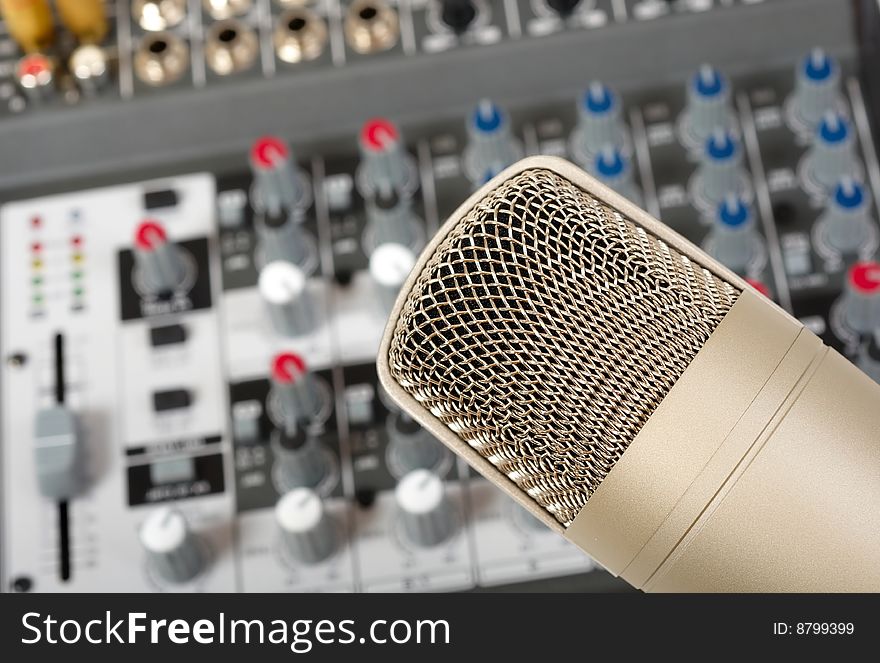 Studio microphone on the audio control console background