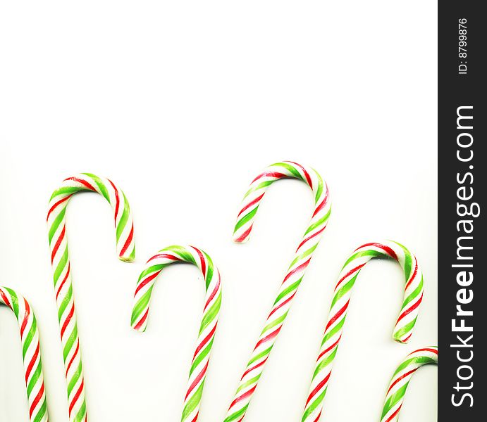 Four red and green Christmas candy canes isolated on white (real photo)