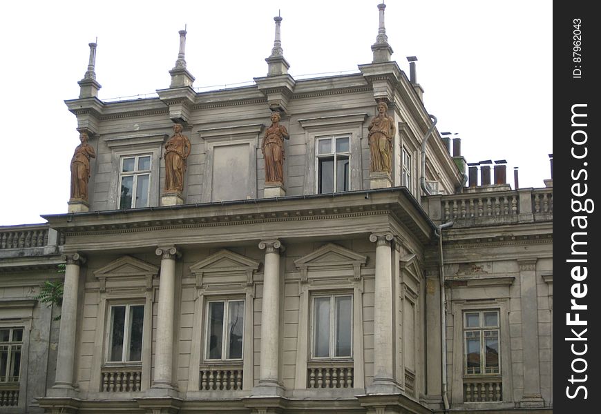 Exterior of a historic building with four statues. Exterior of a historic building with four statues.