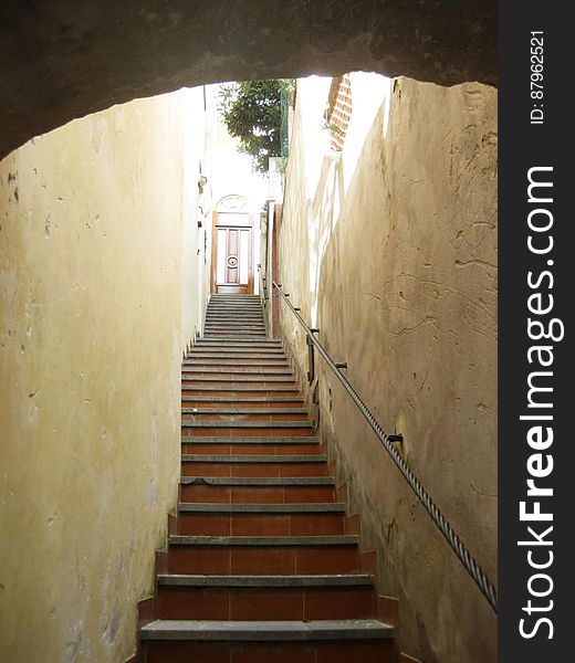 A stairway leading up to a door in the city. A stairway leading up to a door in the city.