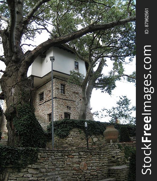 A garden and a building made of stone. A garden and a building made of stone.