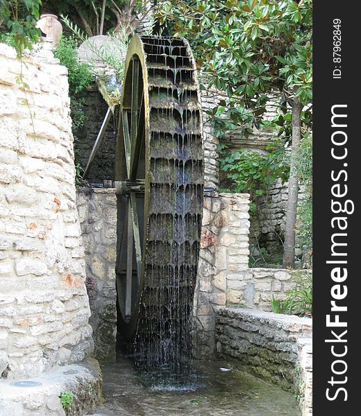An old mill with a water wheel. An old mill with a water wheel.