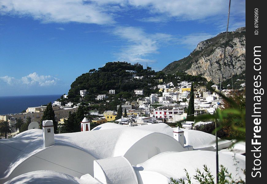 A view over the rooftops of a town on the coast of the Mediterranean sea. A view over the rooftops of a town on the coast of the Mediterranean sea.