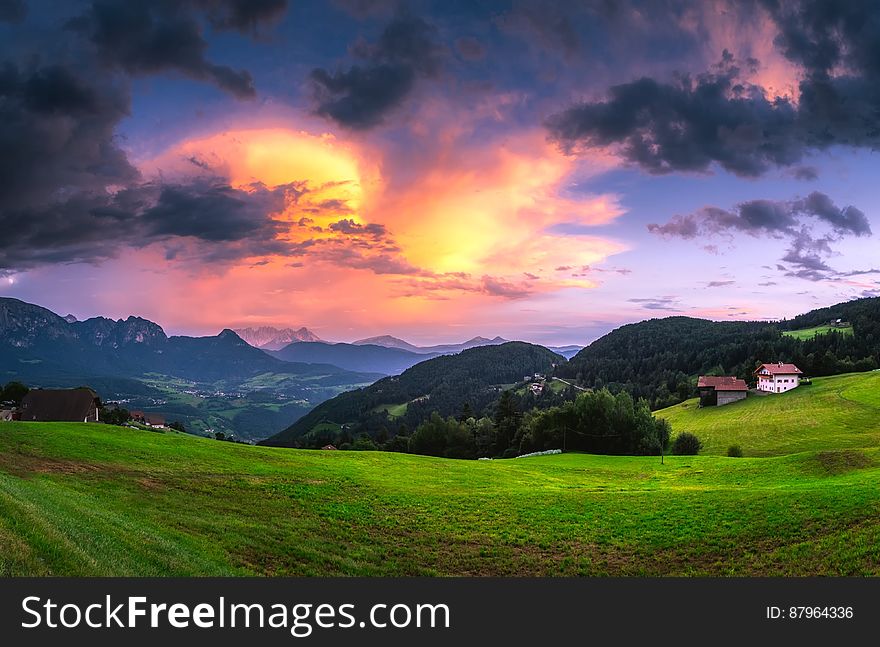 Scenic View of Landscape Against Cloudy Sky