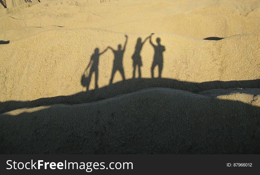 The shadows of happy people on a sand dune. The shadows of happy people on a sand dune.