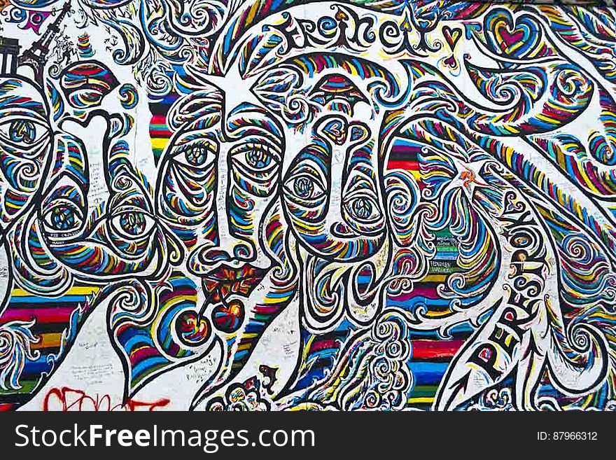 A colorful symbolic graffiti on the Berlin Wall. A colorful symbolic graffiti on the Berlin Wall.