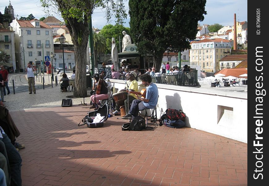 A group of street musicians playing for the people in the city.