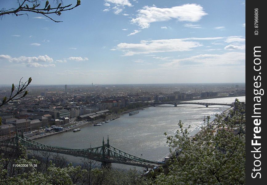 A panoramic view of a river flowing through a city and the bridges across it. A panoramic view of a river flowing through a city and the bridges across it.