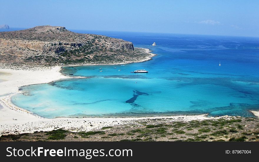 A bay and sandy beach with clear blue waters. A bay and sandy beach with clear blue waters.