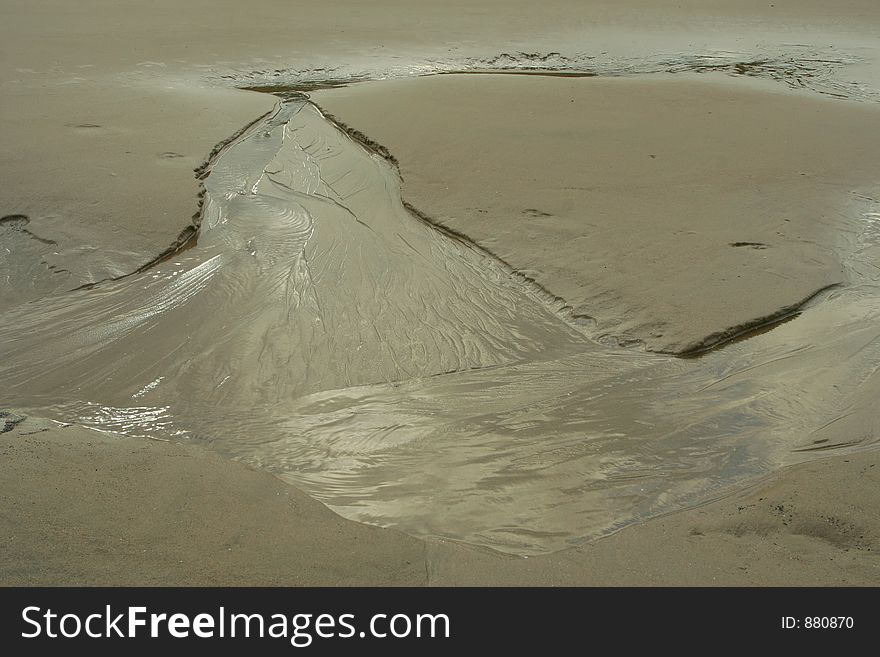 Tide water eroding sand; Oregon beach. Tide water eroding sand; Oregon beach