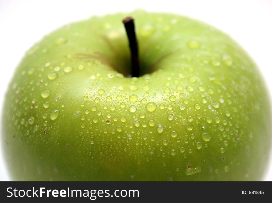 Green apple with drop in closeup