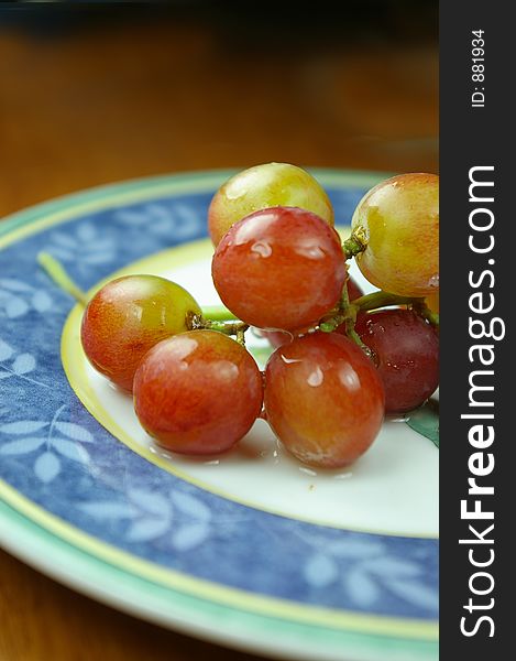A bunch of grapes on a plate. A bunch of grapes on a plate