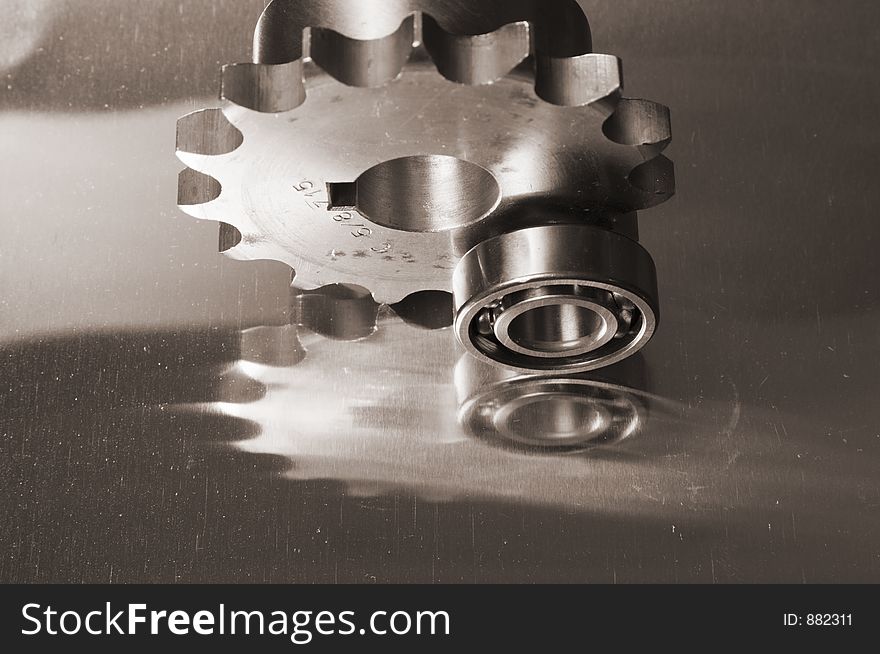 Gears and ball-bearing concept in sepia-toning against titanium. Gears and ball-bearing concept in sepia-toning against titanium