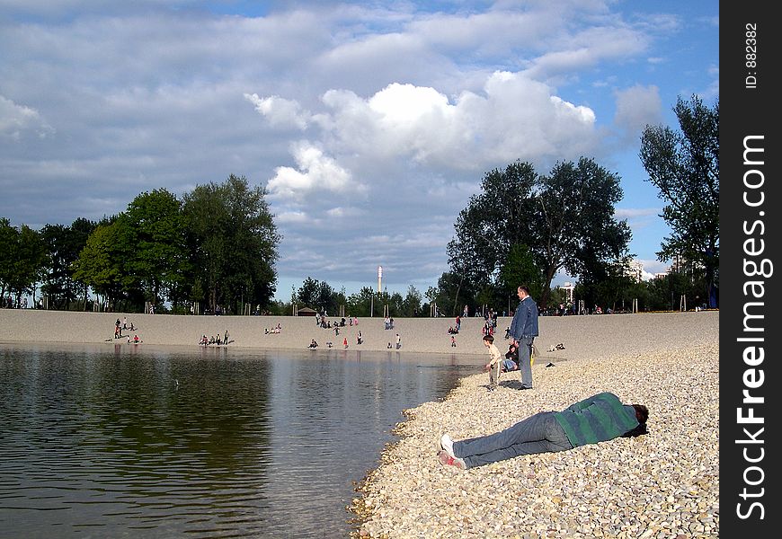 MAN SLEEPING ON BEACH