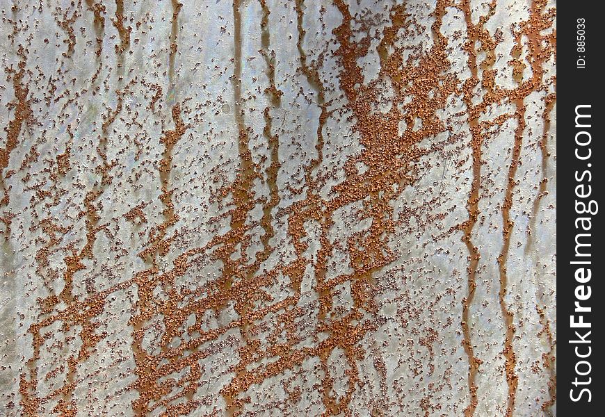 Pattern of rust on a metal plate. Pattern of rust on a metal plate.