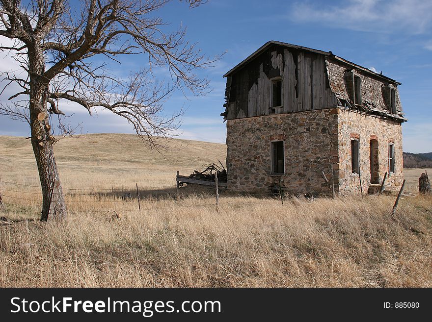 Abandoned house in a dry field of grass. Abandoned house in a dry field of grass