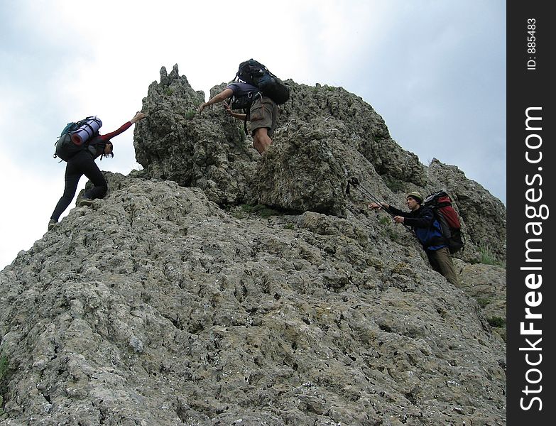 Three climbers in rock