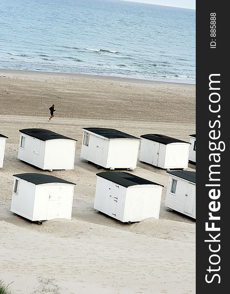 Summer in denmark:beach houses and man running. Summer in denmark:beach houses and man running