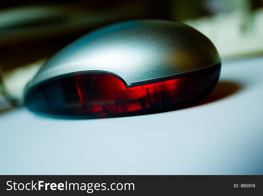 Closeup of an optical mouse on white underground; with trendy shallow depth of focus field;