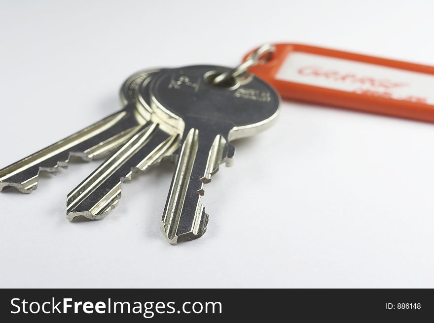 Keys with a red key fob on white background. Keys with a red key fob on white background
