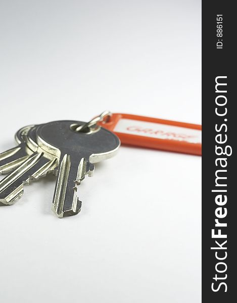 Keys with a red key fob on white background. Keys with a red key fob on white background