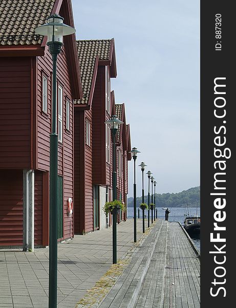 Traditional style, wooden shophouses on the quay in Farsund on the south coast of Norway. Traditional style, wooden shophouses on the quay in Farsund on the south coast of Norway