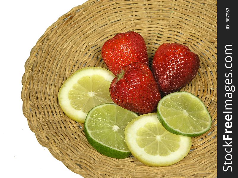 Strawberries,lemon and limes on a woven platter. Strawberries,lemon and limes on a woven platter