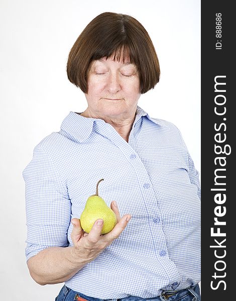 Senior lady holding a pear. Senior lady holding a pear