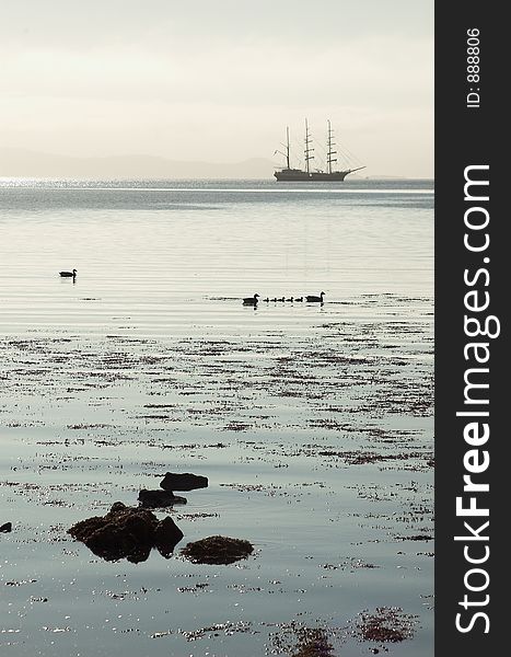 Tall ship silhouette with ducklings on calm waters of Loch Scresort, Rum, Scotland. Tall ship silhouette with ducklings on calm waters of Loch Scresort, Rum, Scotland