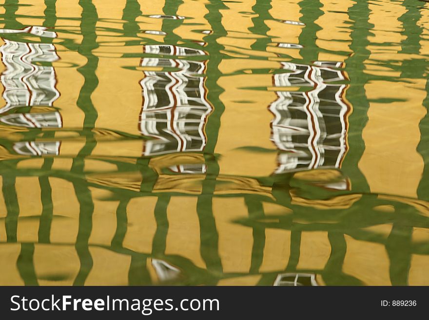 Reflection of a house in water in the street of a danish village in grenaa in the summer