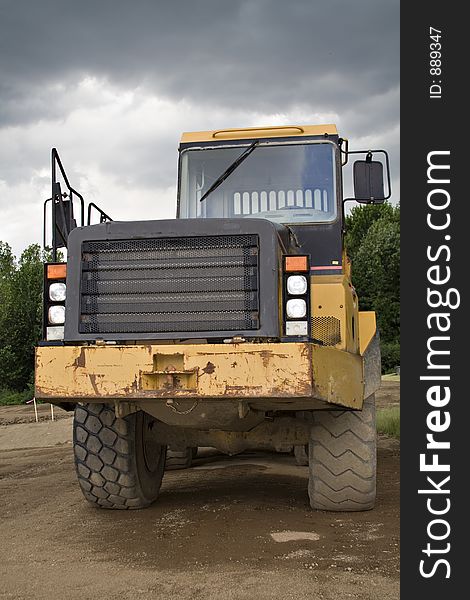 Large earthmover from front.  A stormy sky above. Large earthmover from front.  A stormy sky above.