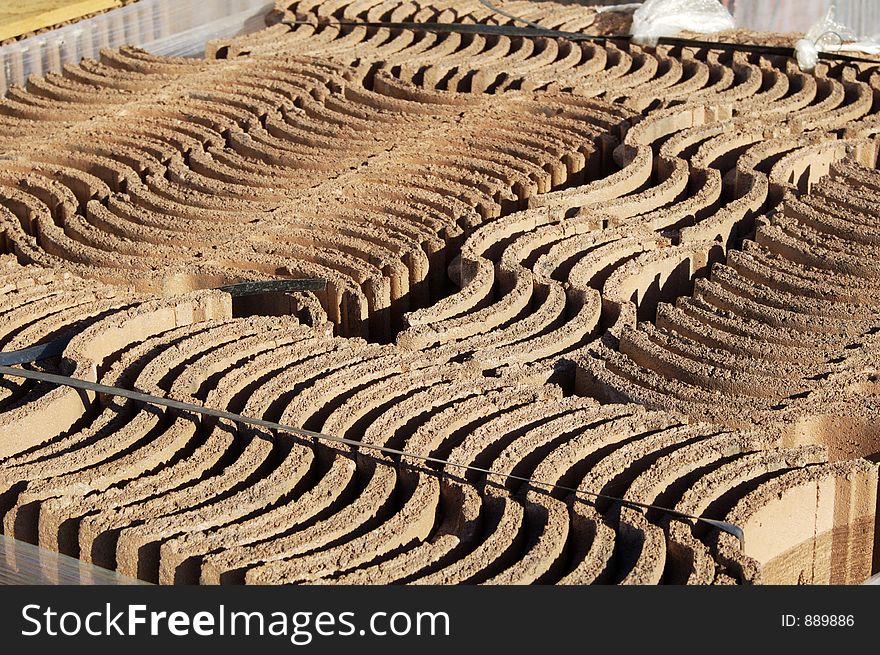 A pallet load of roofing tiles at a residential home construction site. A pallet load of roofing tiles at a residential home construction site.