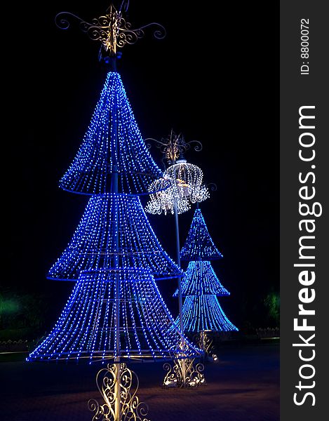 Blue christmas trees against an dark background