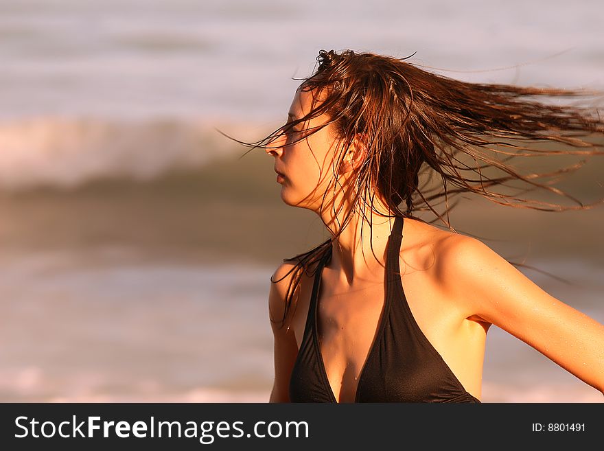 Woman swinging her hair at the beach in caribbean