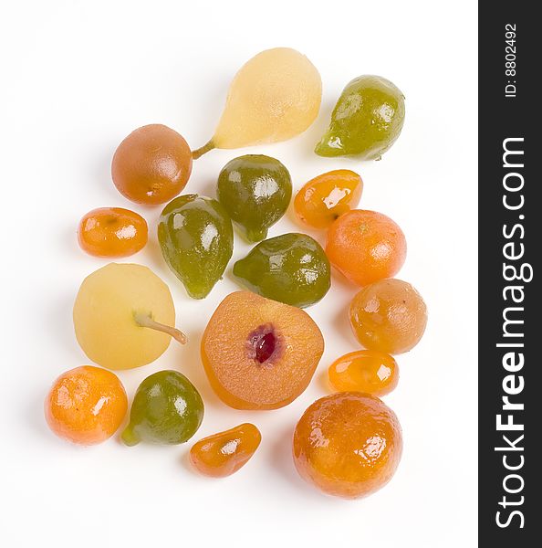 Coloured candied fruits on a white background