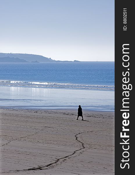 Silhouette of a person walking on the beach. Silhouette of a person walking on the beach