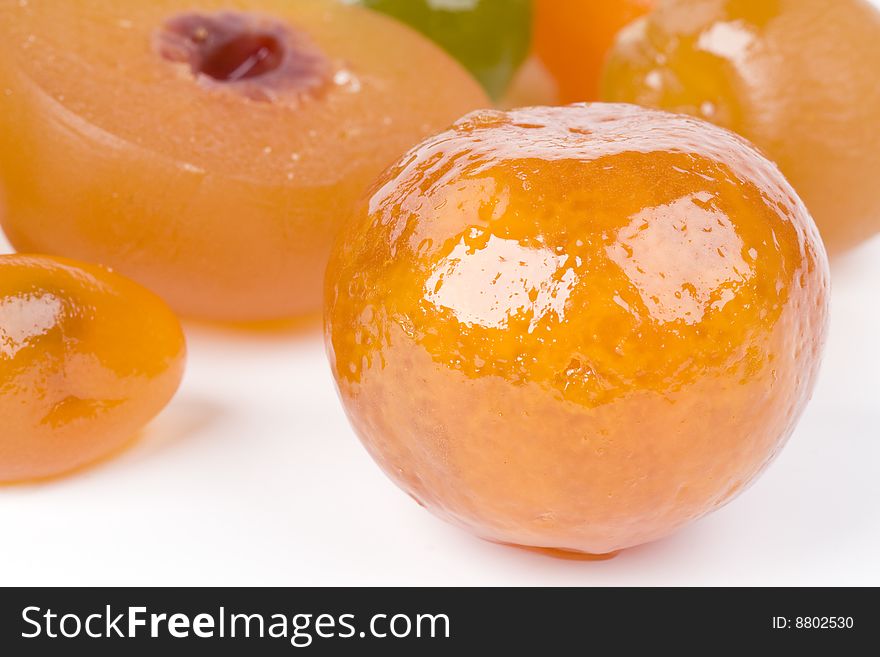 Coloured candied fruits on a white background