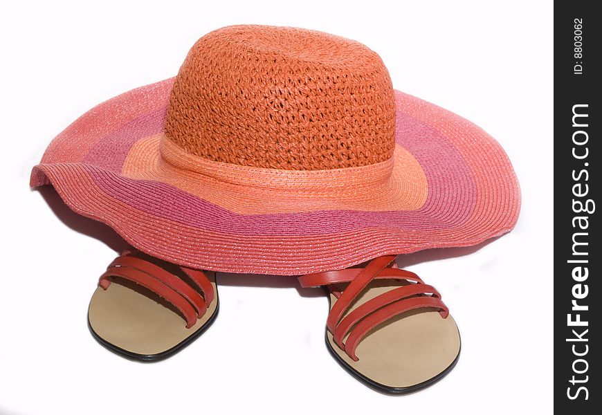 Sandals and hat on white background