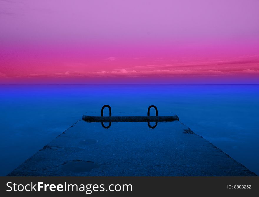 Concrete pier on the sea and blue sky with clouds. Concrete pier on the sea and blue sky with clouds