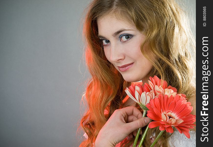 Beautiful young girl with red flowers. Beautiful young girl with red flowers