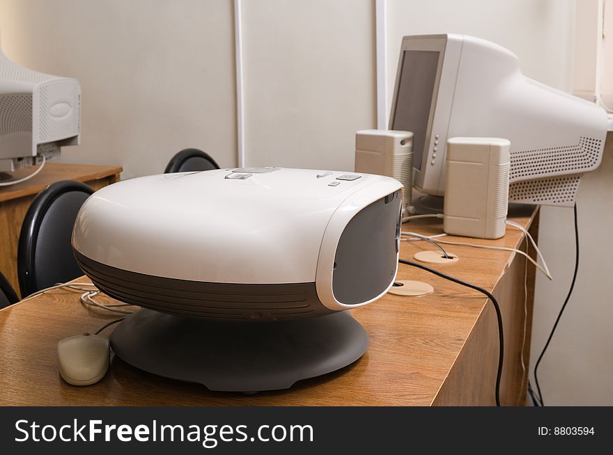 Digital projector and the computer on a table in a lecture hall. Digital projector and the computer on a table in a lecture hall.