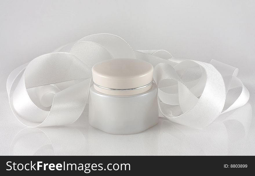 Little jar from cream and white satin ribbon. Little jar from cream and white satin ribbon