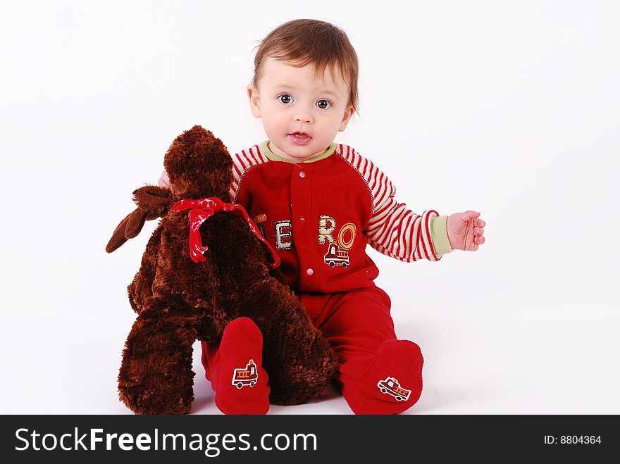 A cute baby boy holding a stuffed animal. A cute baby boy holding a stuffed animal