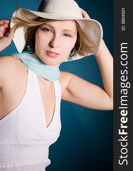 Beautiful woman wearing a hat isolated on blue. Beautiful woman wearing a hat isolated on blue